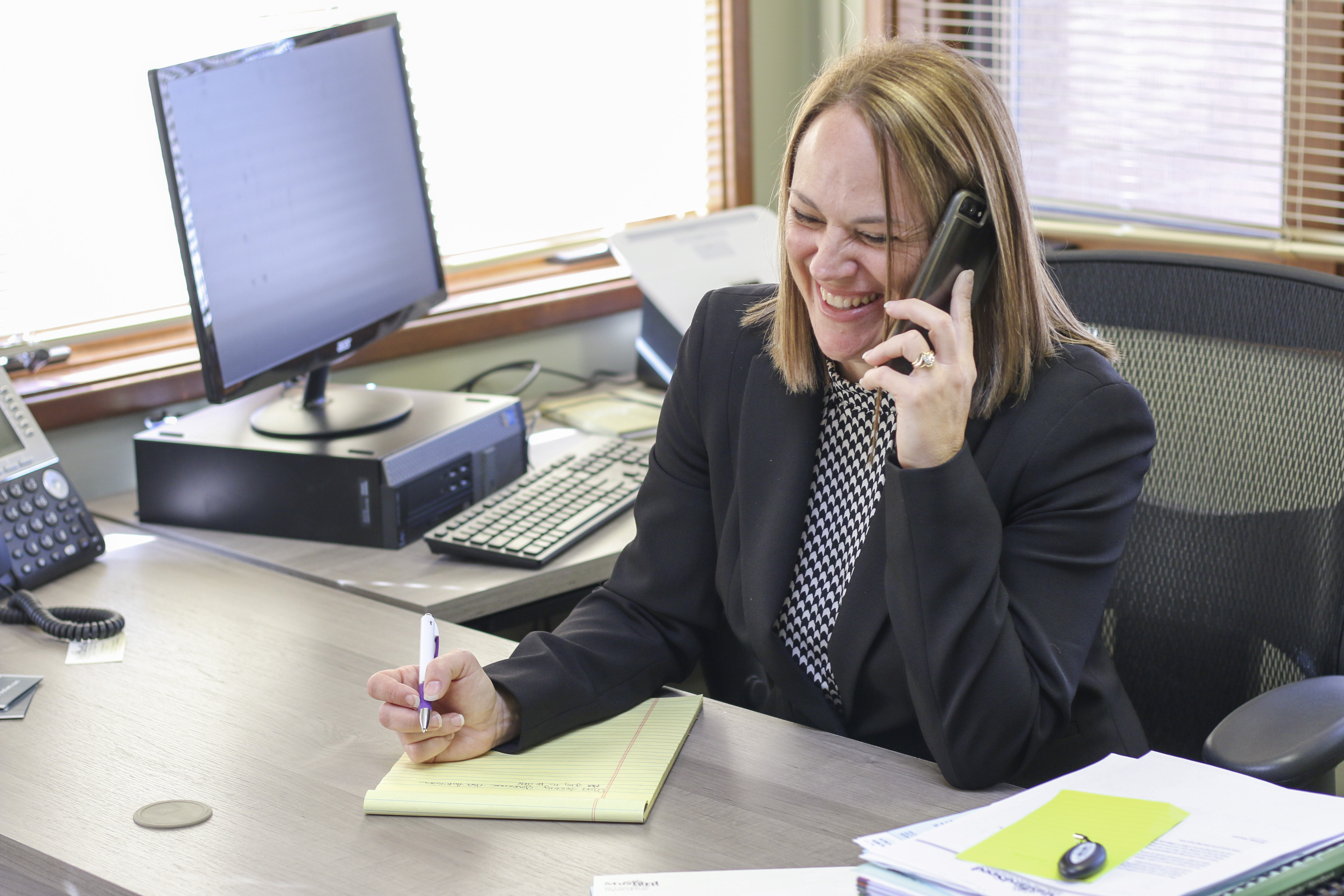 Whitney taking a call from a client to help them with their financial plan.